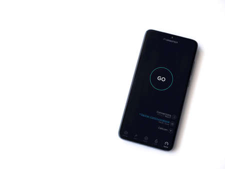 Lod, Israel - July 8, 2020: Speedtest app launch screen with logo on the display of a black mobile smartphone isolated on white background. Top view flat lay with copy space.のeditorial素材