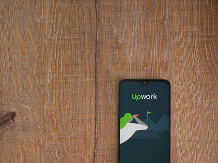 Lod, Israel - July 8, 2020: Upwork app launch screen with logo on the display of a black mobile...