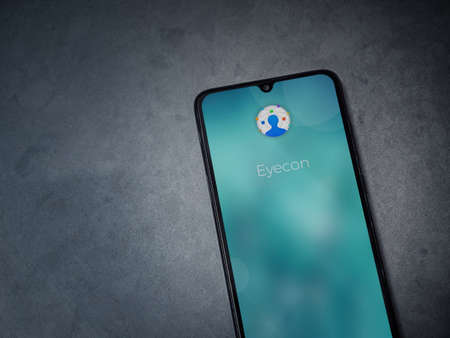 Lod, Israel - July 8, 2020: Eyecon app launch screen with logo on the display of a black mobile smartphone on dark marble stone background. Top view flat lay with copy space.のeditorial素材