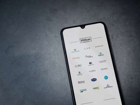 Lod, Israel - July 8, 2020: Hilton Honors app launch screen with logo on the display of a black...