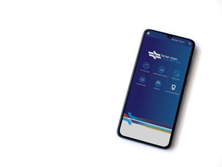Lod, Israel - July 8, 2020: Israel Railways app launch screen with logo in hebrew text on the display of a black mobile smartphone isolated on white background. Top view flat lay with copy space.のeditorial素材