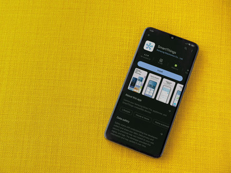 Lod, Israel - July 16,2023: Smartthings app play store page on smartphone on a yellow fabric background. Top view flat lay with copy space.のeditorial素材