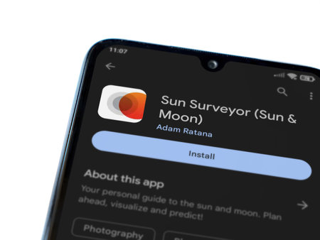 Lod, Israel - July 16,2023: Sun Surveyor app play store page on smartphone on white background. Top view flat lay with copy space.のeditorial素材
