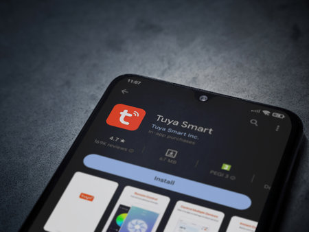 Lod, Israel - July 16,2023: Tuya Smart app play store page on smartphone on a dark marble stone background. Top view flat lay with copy space.のeditorial素材