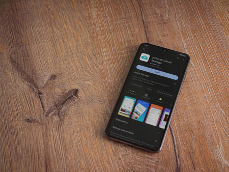 Lod, Israel - July 16,2023: pCloud app play store page on smartphone on wooden background. Top view flat lay with copy space.のeditorial素材
