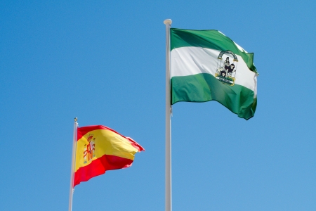 Spanish and Andalucian Flags on blue sky Spanish and Andalucian Flags on blue sky