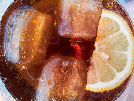Soft drink with cola and a slice of lemon (top view)の写真素材