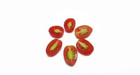 Grape tomatoes cut up in white backgroundの写真素材
