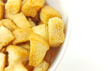 Bowl of close up of crispy bread on white backgroundの写真素材