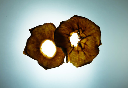 Dehydrated red apple on light tracing board backgroundの写真素材