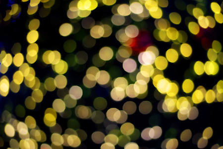 Yellow bokeh on black background; defocusedの写真素材