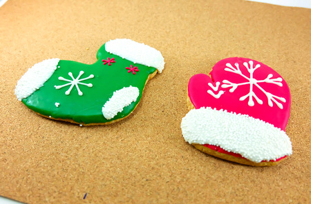 Christmas cookies; green sock and red glove on wodden backgroundの写真素材