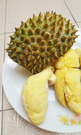 Peeling durian on white plate, yellow color, King of fruitsの写真素材