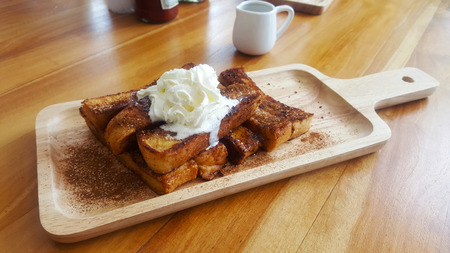 Chocolate and vanilla french toast with cinnamon sugar on wooden plateの写真素材