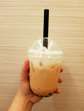 Pearl bubbles iced milk tea on brown backgroundの写真素材