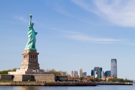 Looking at Statue of Liberty from the floating boat, with Manhattan Skyline far behindの写真素材