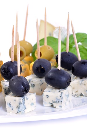 Appetizer plate with cheese and olives isolated on white backgroundの写真素材