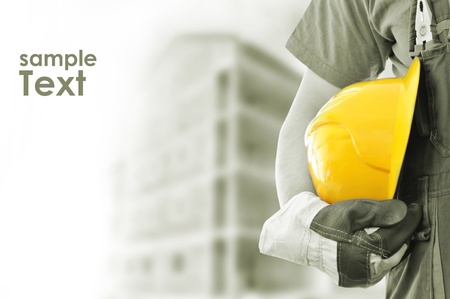 Worker and the blurred construction in background with space for your text Worker and the blurred construction in background with space for your text