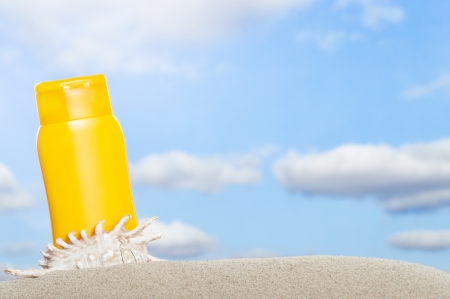 Tube with sun protection on beach and blue sky in backgroundの写真素材
