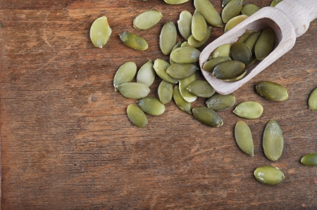 Pumpkin seeds on a wooden tableの写真素材