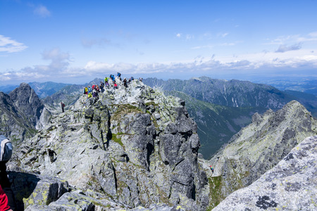 RYSY PEAK, POLAND - JULY 10 : People on top of the Rysy peak at High Tatras. Rysy are the highest mount of Poland. July 10, 2015 in Rysy Peak, Poland.のeditorial素材