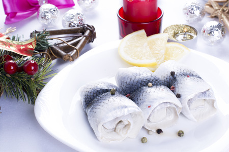 Rollmops with lemon for Christmas on a plateの写真素材