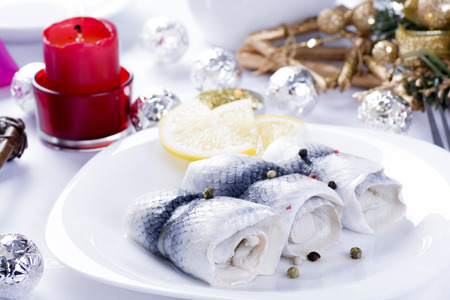 Rollmops with lemon for Christmas on a plateの写真素材
