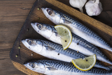 Mackerel with lemon and garlic at cutting tableの写真素材