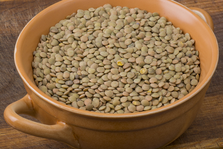 Lentil in bowl on wooden tableの写真素材