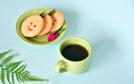 Smiling face cookies isolated with a blue light backgroundの写真素材