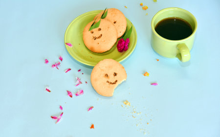 Smiling face cookies isolated with a blue light backgroundの写真素材