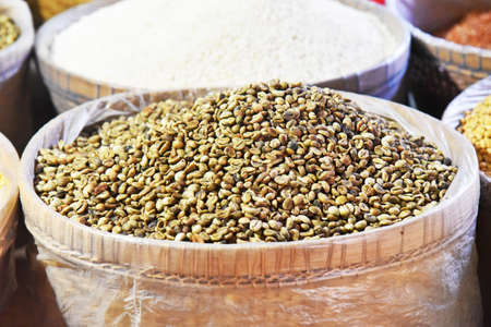Fresh coffee beans in green brown color place on the bambu basket in the marketの写真素材