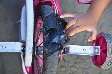 Broken kids bicycle tire need a maintenance