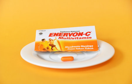 BALI,INDONESIA-AUGUST 09 2021: Multivitamin for adult in yellow color isolated on color background
