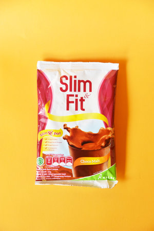BALI,INDONESIA-AUGUST 09 2021: Diet drink "Slim Fit" isolated on yellow backgroundのeditorial素材