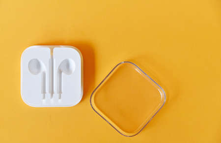 Ear phone box in white color isolated on yellow backgroundの写真素材