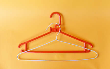 Clooth hanger in red and white color on yellow backgroundの写真素材