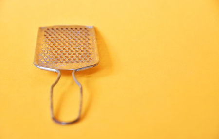 Cheese slicer isolated on yellow background