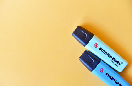 BALI,INDONESIA-AUGUST 09 2021:Highlighter (Stabilo) with blue color on yellow backgroundのeditorial素材