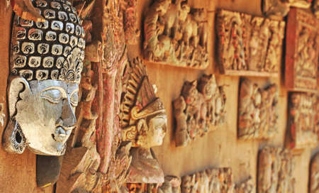 Wooden Buddha mask on silver color in close upの写真素材