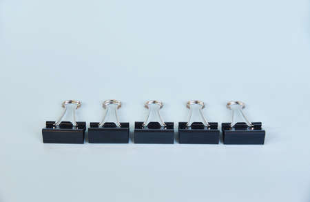 Metal paper clips in special arrangement isolated on color background