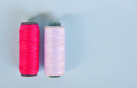 Sewing thread on white and red color,isolated on color background