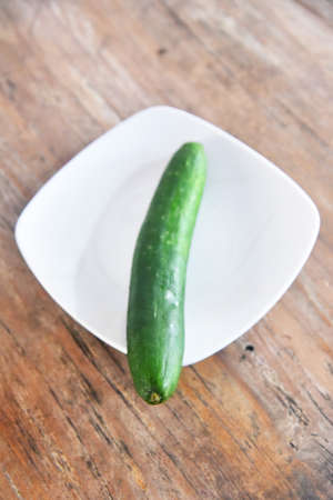 Cucumber vegetable placed on the brown wooden tableの写真素材