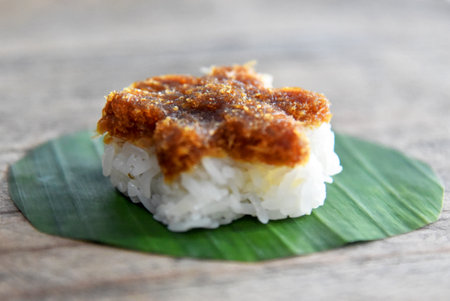 Traditional indonesian rice cake in star form,with coconut palm sugar sauce,served with banana leafs...