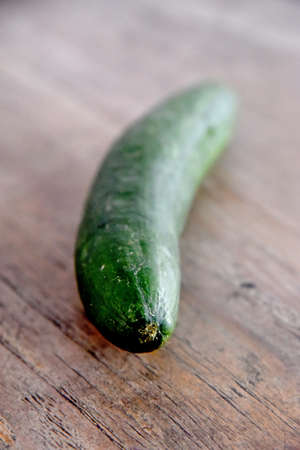 Cucumber vegetable placed on the brown wooden tableの写真素材
