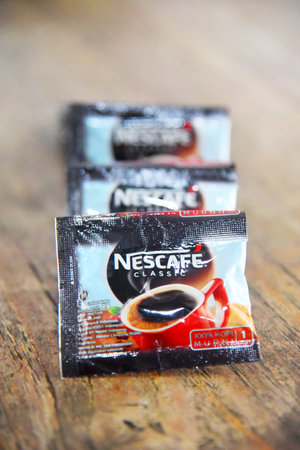 BALI,INDONESIA - March 22 2022: Manufacture coffee product brands"NESCAFE",placed on brown wooden tableのeditorial素材