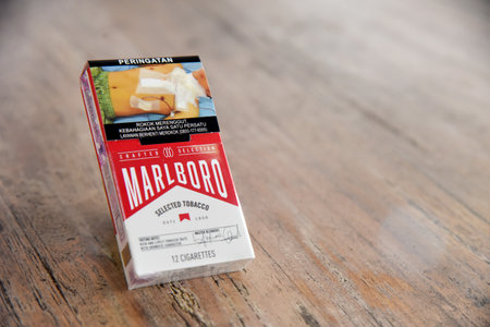 Bali,indonesia - April 08 2022 : Cigarette pruduct,with commercial brand packed,placed on brown wooden backgroundのeditorial素材