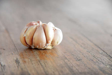 Close up of garlic,placed on the wooden backgroundの写真素材