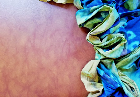 Traditional Indonesian Batik cloth,placed on brown color  background