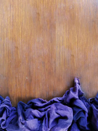Blue,purple cloth,placed on brown wooden backgroundの写真素材